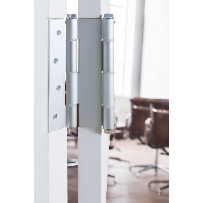Charnière double action à fermeture automatique pour portes battantes